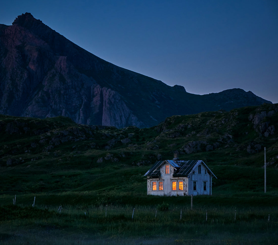 alt= A quaint house surrounded by a vast field.