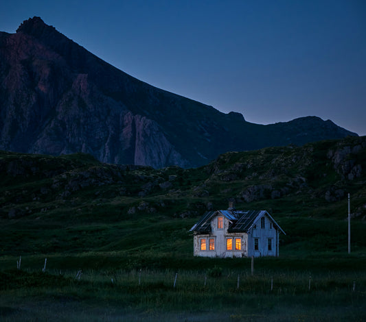 alt= A quaint house surrounded by a vast field.